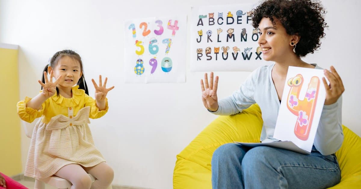 Teacher and child counting objects together in a preschool classroom to assess early math skills.