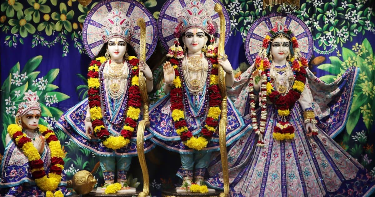 Hindu statues adorned with floral garlands in a temple, illustrating the sacred imagery central to Ramayana traditions during Diwali.