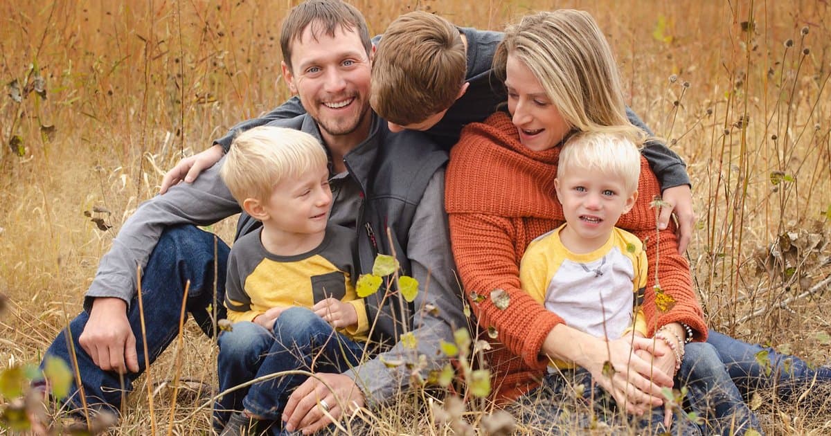 A family of five sitting together in an autumn field, illustrating memory-making moments in blended families.