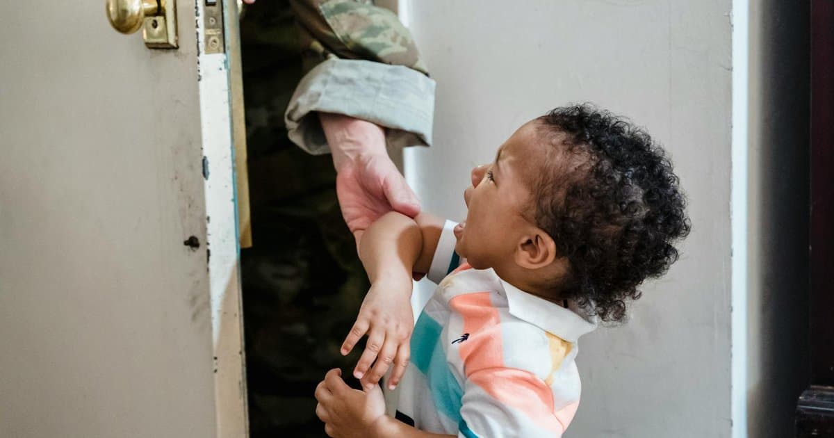A young child cries as a parent leaves, illustrating separation anxiety at preschool start.