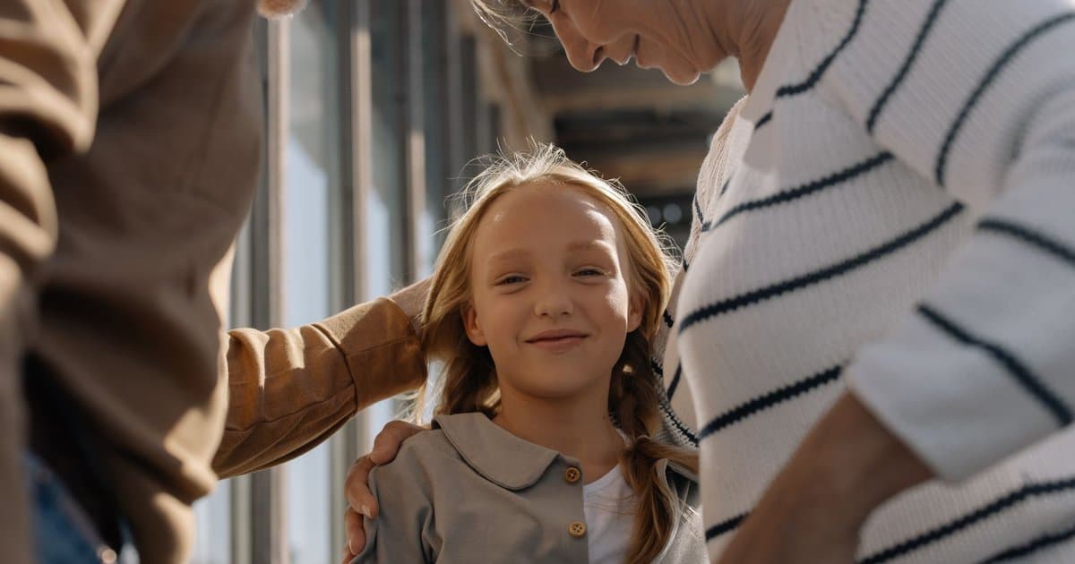Young girl hugging her grandparents, illustrating the meaningful connections that thoughtful gifts can strengthen.