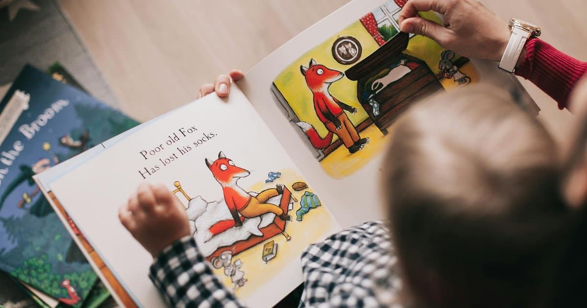Child and adult reading an illustrated book together, showing how personalized stories engage young readers.