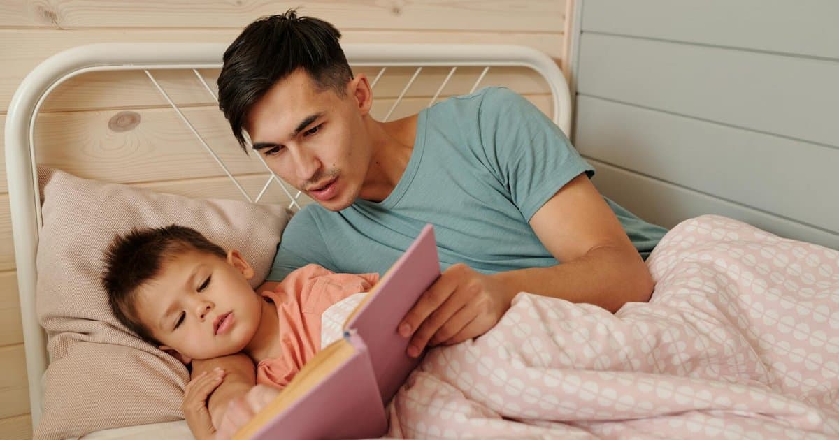 Father reading a bedtime story to his son, showing the impact of personalized storytelling.