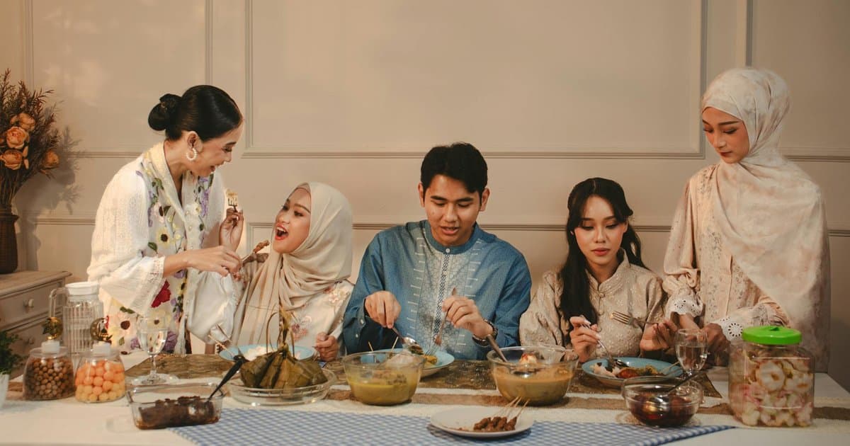 Family sharing a meal together indoors, connecting over food during Ramadan celebrations.