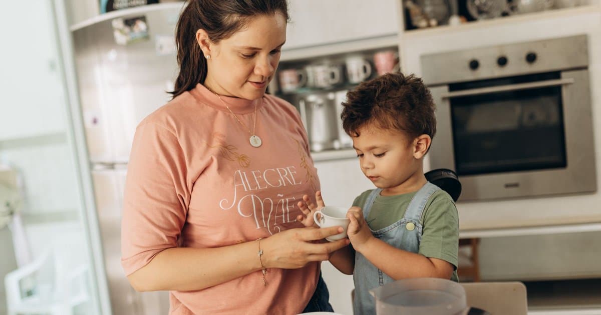 Mother and young son preparing food together in a kitchen, demonstrating gratitude through shared family activities.