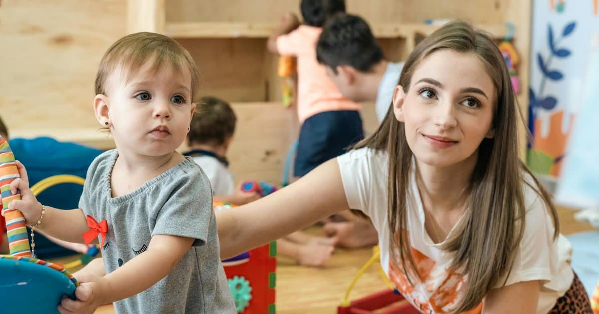 A mother and baby playing in a nursery room, representing the caregiving relationships that inspire parent gift-giving.