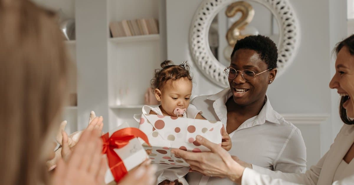 Father and daughter opening gifts together, illustrating thoughtful present-giving for teachers.